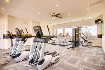 A gym with treadmills and elliptical machines.